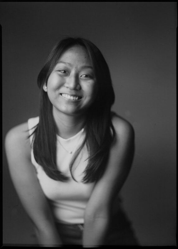 Black and white portrait of Aileen Mae Sze smiling, seated