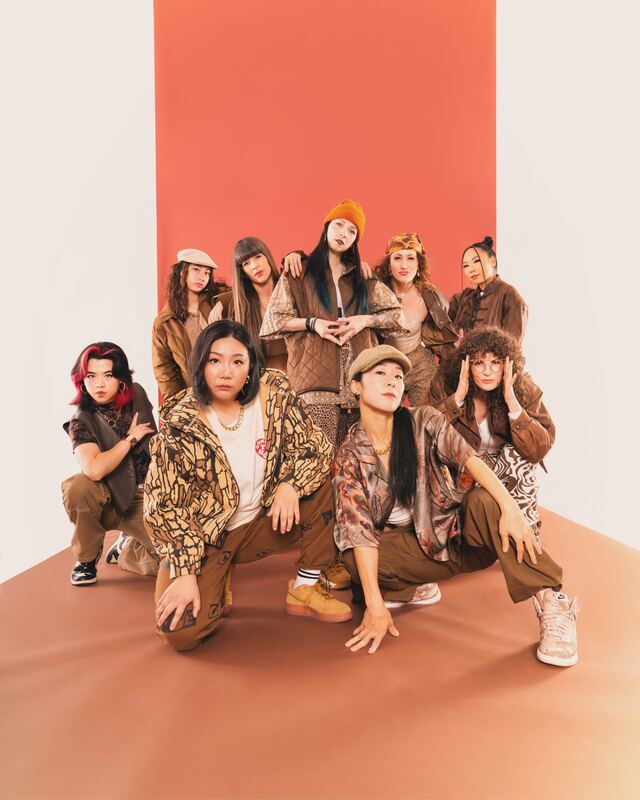 The Diamonds Crew dancers in a group on a terracotta studio backdrop