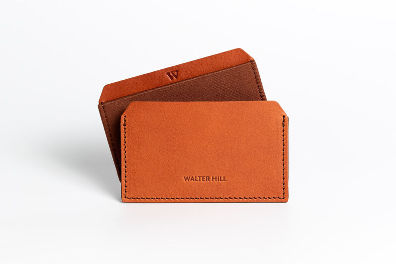 A tan leather Walter Hill card holder on white