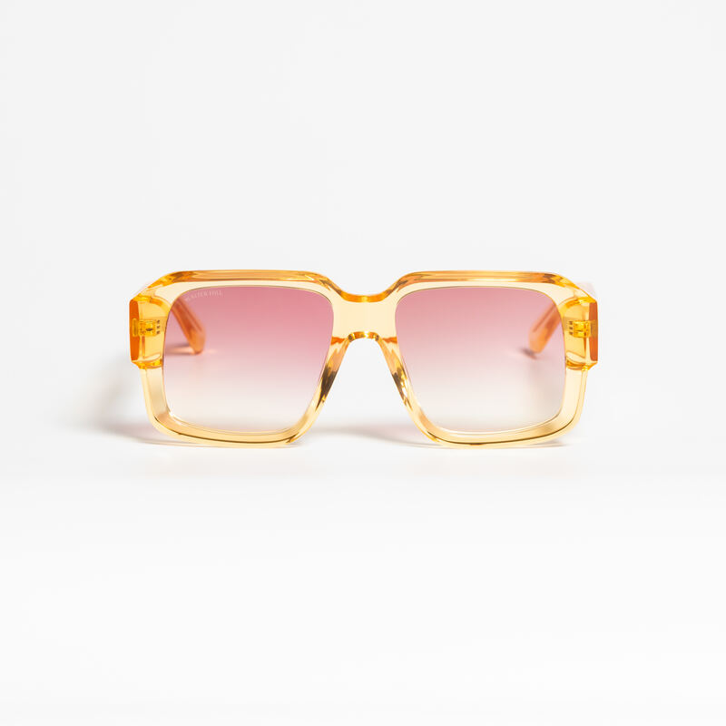 Orange-tinted Walter Hill AJ sunglasses in a translucent amber frame, on white