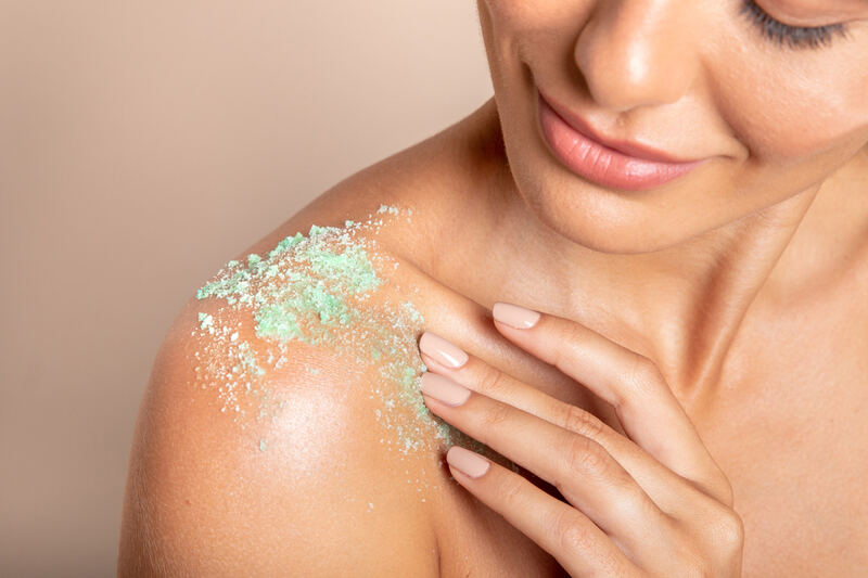 Close-up of a shoulder with a green body scrub